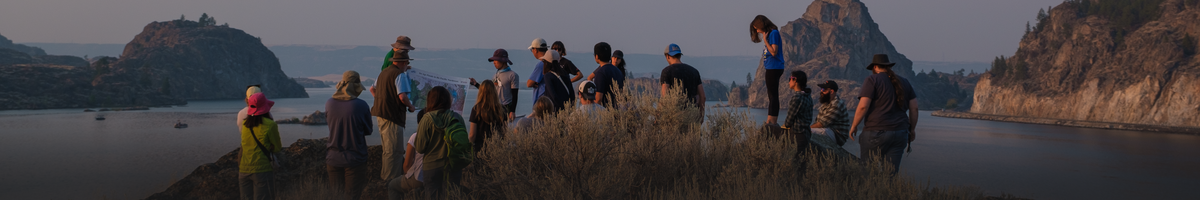 EPSS students gather around a hill overlooking a lake in Washington.